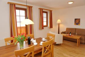 a living room with a table and a dining room at Stranach Appartements in Sankt Michael im Lungau