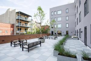 a courtyard with benches and tables and buildings at Hoboken 2br w wd gym nr light rail NYC-946 in Hoboken