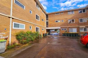 an empty parking lot next to a brick building at 2 Bed Apartment York Street Sale in Sale