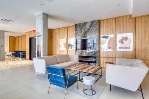 a living room with a couch and chairs and a table at Dumbo 1br w gym roof nr TimeOut Building NYC-958 in Brooklyn