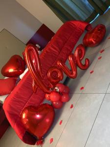un groupe de ballons cardiaques rouges sur le sol dans l'établissement Victoria Hotel, à Pomigliano dʼArco