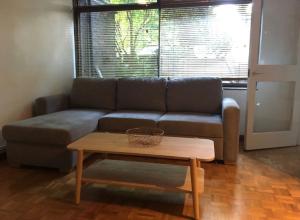 a living room with a couch and a coffee table at Victoria Park 1 bedroom flat in London