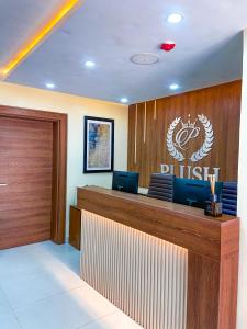 um escritório com uma secretária com um sinal de dhl sobre ele em Plush Hotel,Abuja em Abuja