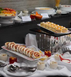 a buffet with several plates of food and desserts at The Zabeer Dhaka in Dhaka
