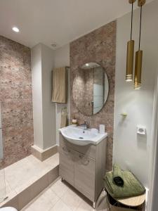 a bathroom with a sink and a mirror at Syntagma Hideaway Luxury Apt in Athens