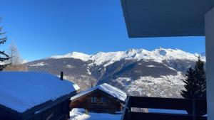 a snow covered cabin with mountains in the background at Escapade montagnarde idéale ! in Vex