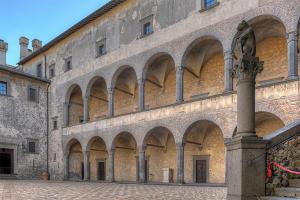 a large building with arches on the side of it at Casuale House in Castel SantʼElia