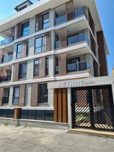 a tall white building with a referro sign in front of it at Retro 3 in Alanya