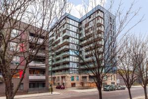 a tall apartment building on the corner of a street at The Thames Collection in London