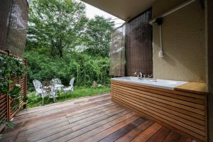 a bathroom with a sink on a wooden deck at 『花の影』カップル、ご友人、ご家族利用完全貸切!広々テラス露天風呂付!ポーラ美術館徒歩5分 in Hakone