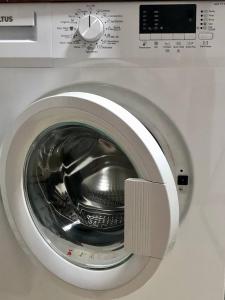 a close up of a washing machine with its door open at Hotel Tbilisi Guest Home in Tbilisi City