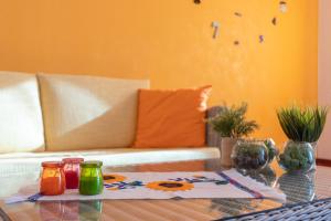 a living room with a table and a couch at Sole e Girasoli in Molfetta +20 photos