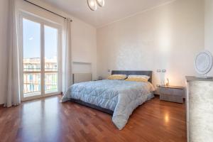 a bedroom with a bed and a large window at Sole e Girasoli in Molfetta
