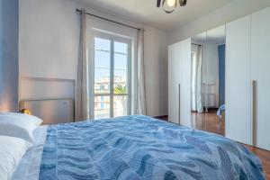 a bedroom with a bed with a blue comforter at Sole e Girasoli in Molfetta
