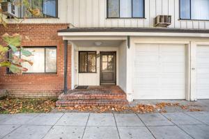 a brick house with two white garage doors at Blueground Beverly Hills nr bars groceries LAX-1183 in Los Angeles