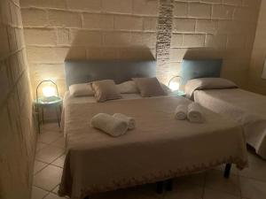 a bedroom with two beds with towels on it at La Stanza in Bari