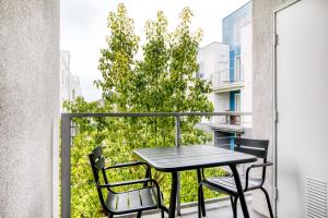 a black table and chairs on a balcony with a tree at Playa Vista 1br w pool wd gym nr beach LAX-930 in Los Angeles