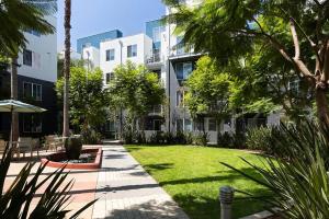 a courtyard of a building with a lawn and trees at Playa Vista 1br w pool wd gym nr beach LAX-930 in Los Angeles