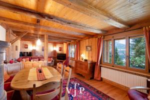 a dining room with a wooden table in a house at L'Alouvy Winter Dream Chalet for Family at Verbier in Verbier