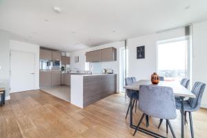 a kitchen and dining room with a table and chairs at The Thames Collection in London