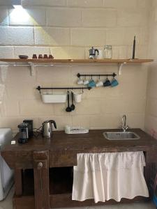 a kitchen with a wooden counter with a sink at La Stanza in Bari