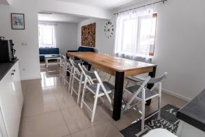 a kitchen and dining room with a wooden table and chairs at Casa Tinca 1 in Izvoru Mureşului +31 photos