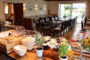 a table with a buffet of food in a restaurant at Hotel Gästehaus Neubauer in Kaltenberg