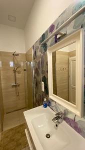 bagno con lavandino, doccia e specchio di Stylish Apartment near the river a Budapest