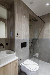 ロードス・タウンにあるLuxury Apartments Of Colossusのトイレ、洗面台、シャワー付きのバスルーム