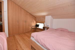 a bedroom with a bed and a chair in it at Fantastic renovated Chalet in the heart of Alps in Münster