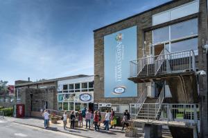 a group of people walking in front of a building at Penglais Lodge in Aberystwyth