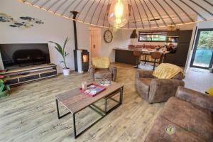 a living room with a couch and a table at Le petit marius in Pleumeur-Bodou