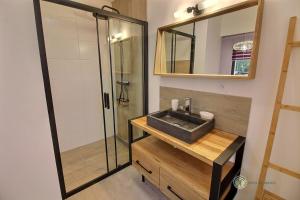 a bathroom with a sink and a shower at Le petit marius in Pleumeur-Bodou +19 photos