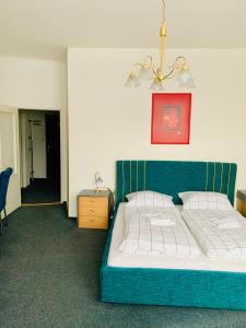1 dormitorio con 1 cama con cabecero azul en Hotel Slovan, en Žilina