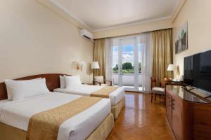 A bed or beds in a room at Inya Lake Hotel Yangon