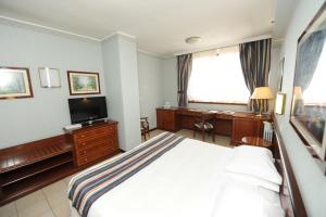 TV a/nebo společenská místnost v ubytování Ripamonti Residence & Hotel Milano