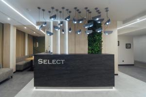 a lobby with a sellert sign on a table at Select Hotel in Lviv