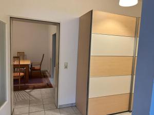 a room with a sliding glass door and a dining room at Wiehengebirgs Fernblick App 2 in Bad Essen