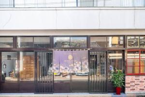 a store front with a banner in front of it at まろや四季 in Ōzu