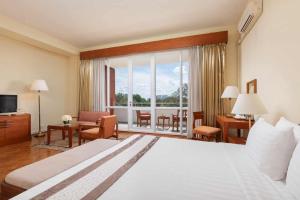 A bed or beds in a room at Inya Lake Hotel Yangon