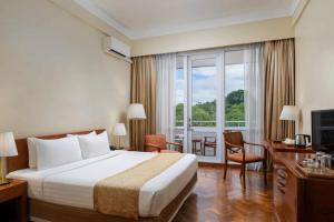 A bed or beds in a room at Inya Lake Hotel Yangon