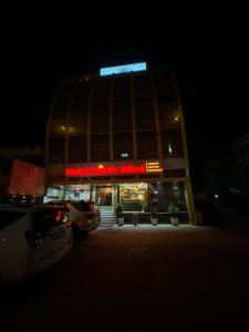 a building with a car parked in front of it at night at Hotel Northwind Mohali in Mohali