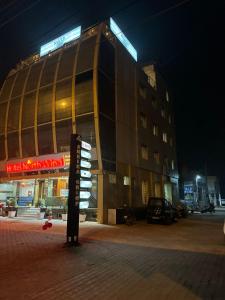 a building with a sign in front of it at night at Hotel Northwind Mohali in Mohali