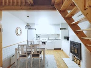 a kitchen with a dining table and a fireplace at Borealis in Saariselka