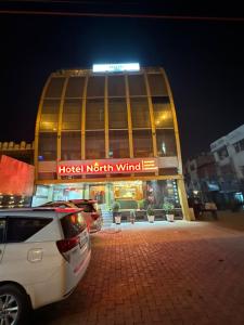 hotel północny wiatr budynku z samochodem zaparkowanym przed w obiekcie Hotel Northwind Mohali w mieście Mohali