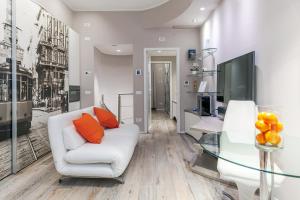 a living room with a white couch and a glass table at [DUOMO 14 min] Orange Milano M3 in Milan