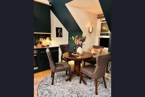 a dining room with a table and chairs at The Maple Retreat - Hampstead in London