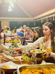 a group of people sitting at a table eating food at Abdallah shaheen wadi rum in Disah +23 photos