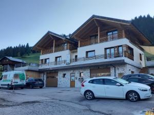 a white car parked in front of a building at B&B IL BUCANEVE in Santo Stefano di Cadore