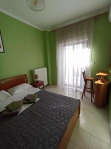 a bedroom with a large bed and a window at House Eugenia Sarti in Sarti